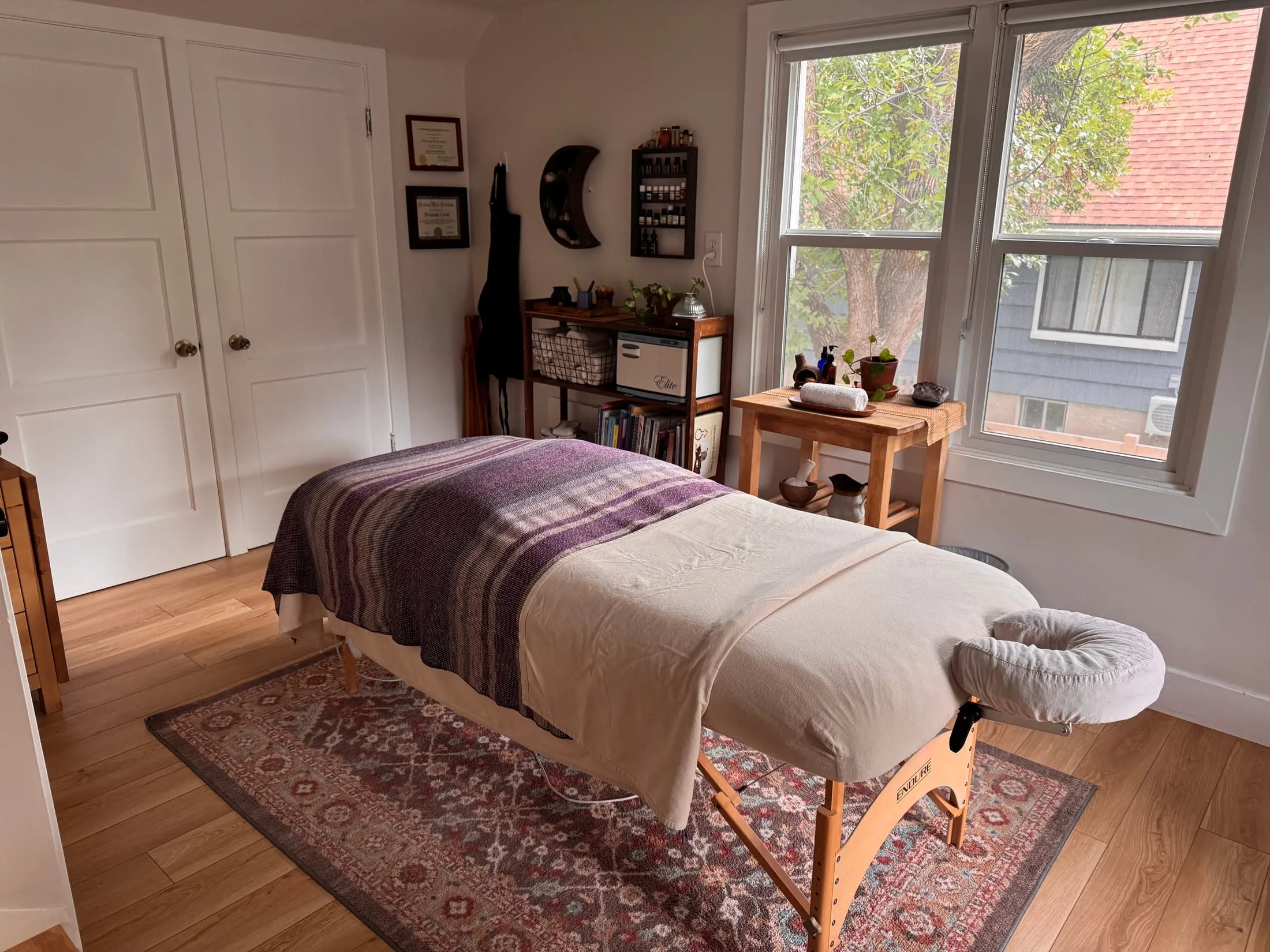 The treatment room from the doorway, with the table made up beside a bright window